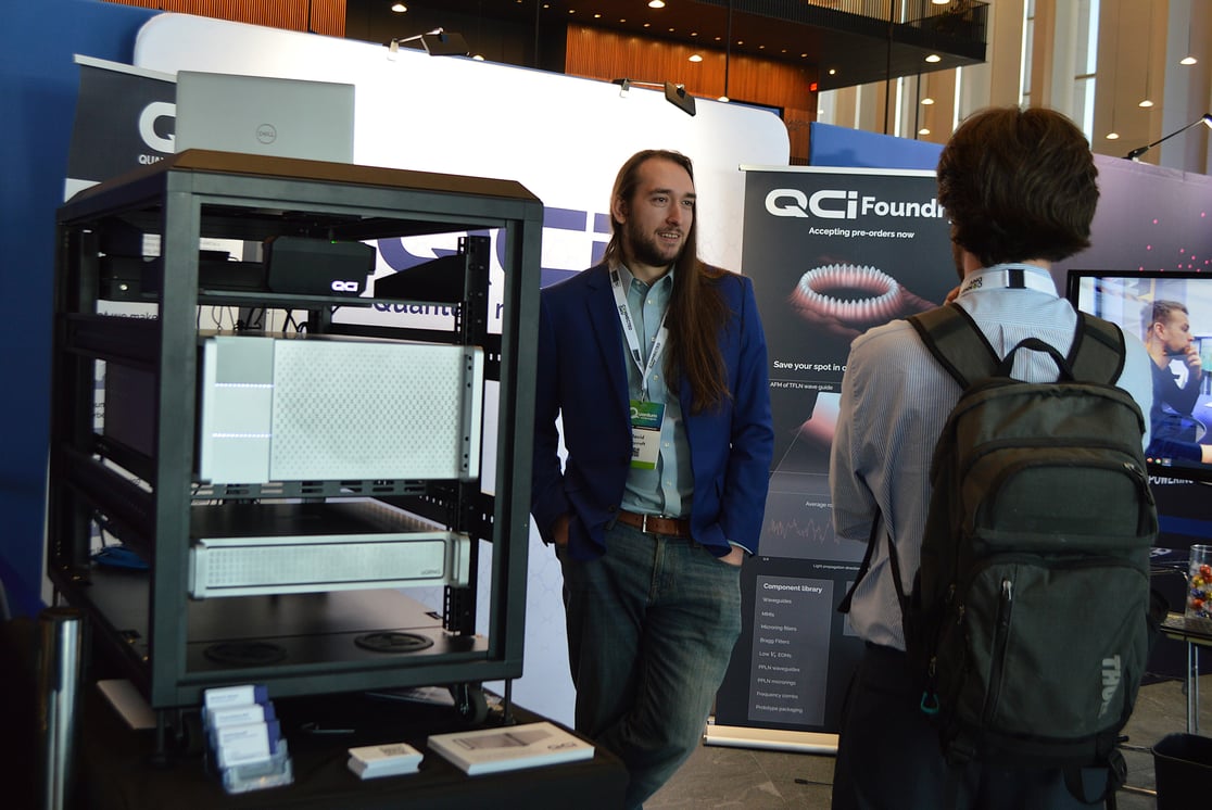 QCi Networking at Booth at QWC 2024
